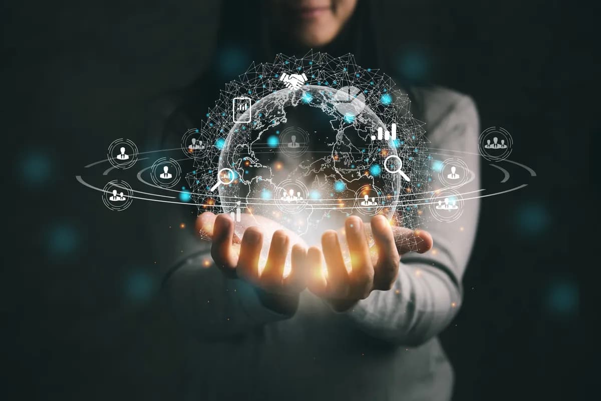 Hands holding a glowing globe of connected network points, a symbol of international communication