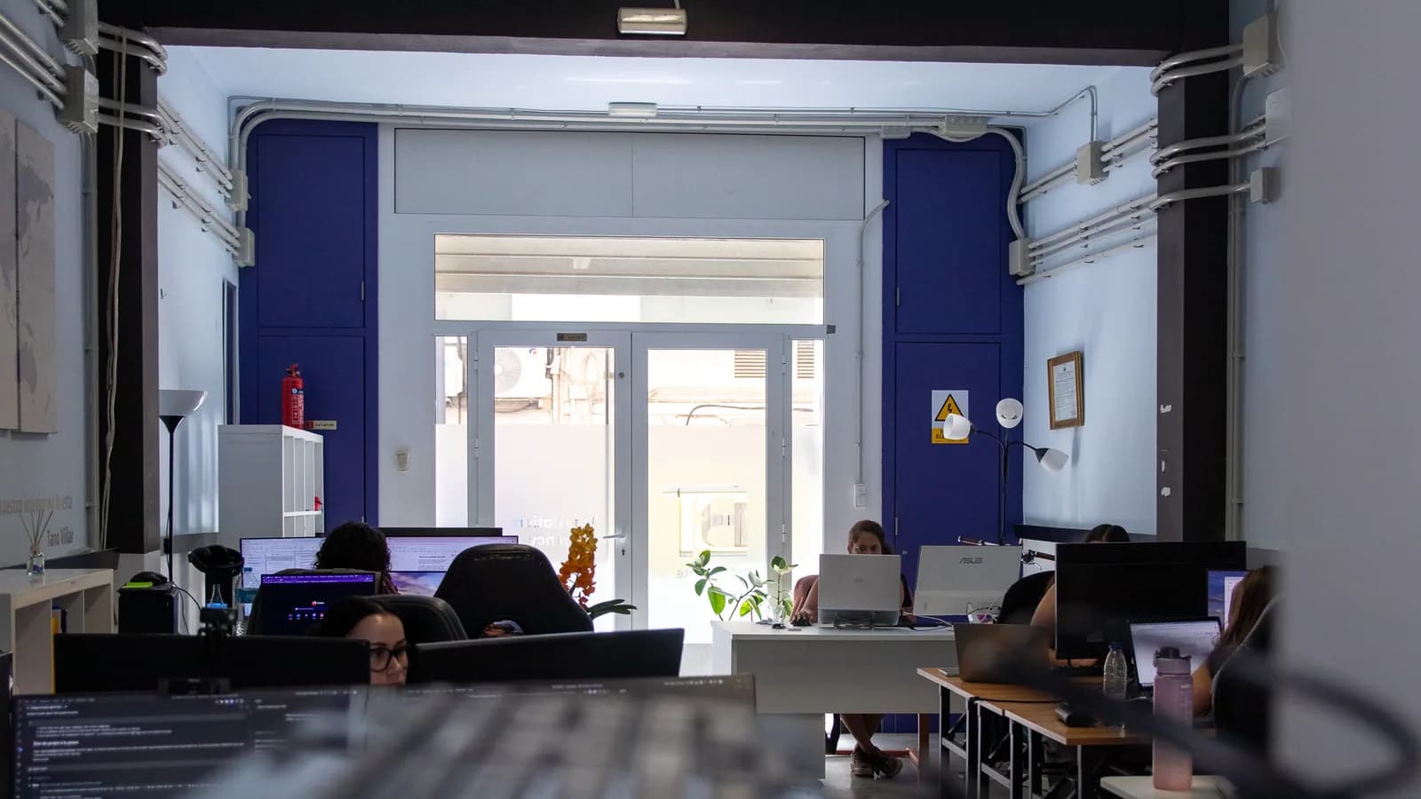 Bright professional office workspace with desks and a city view through the windows