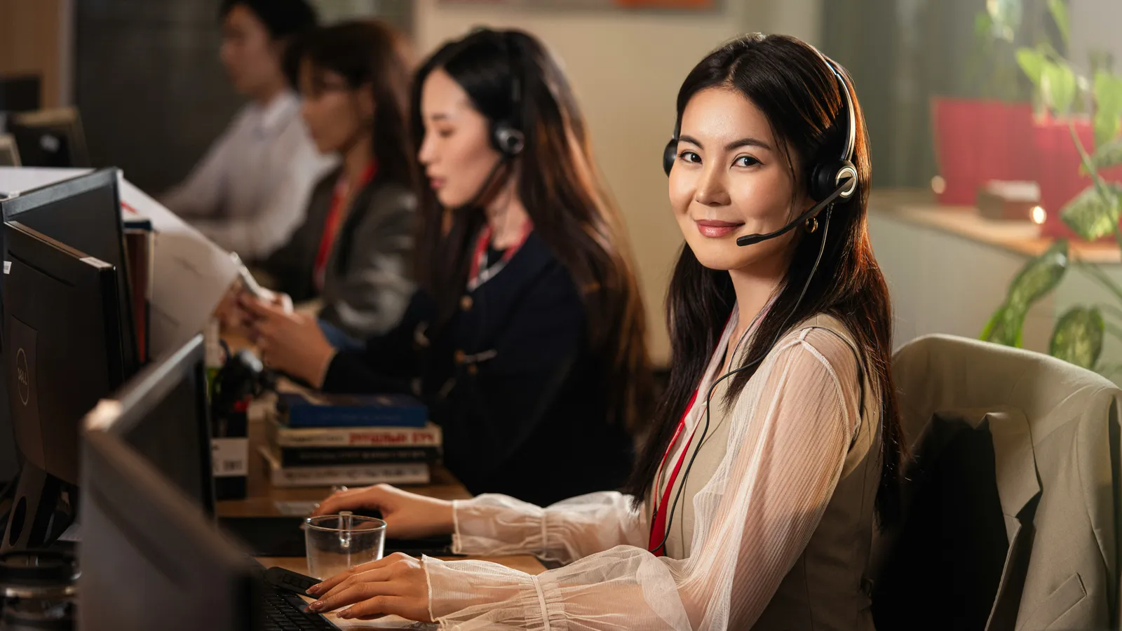 Interpreters wearing headsets seated close to delegates during a working session